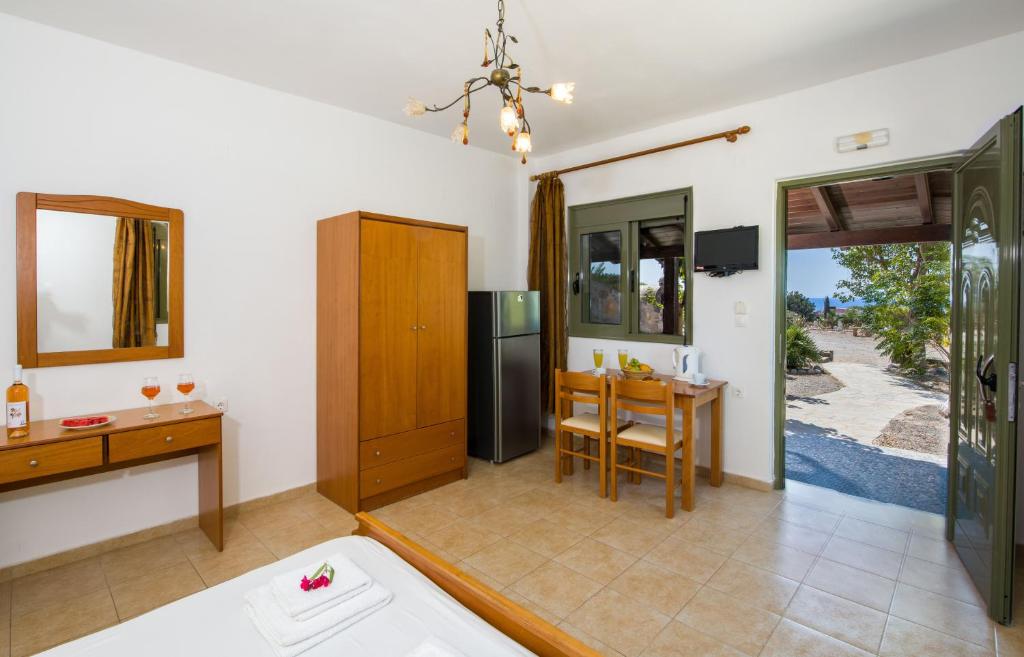 a room with a kitchen and a dining room at Elafonisi Village in Elafonisi