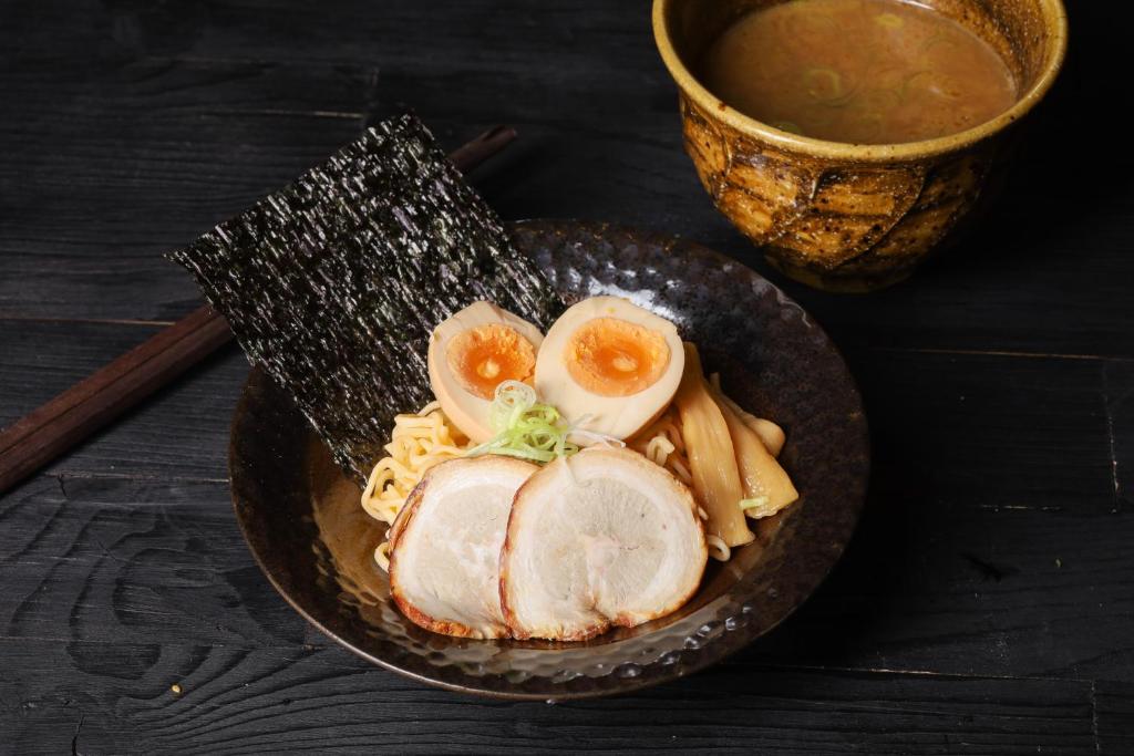 a plate of food with chicken and eggs on a table at InterContinental Phuket Resort by IHG in Kamala Beach