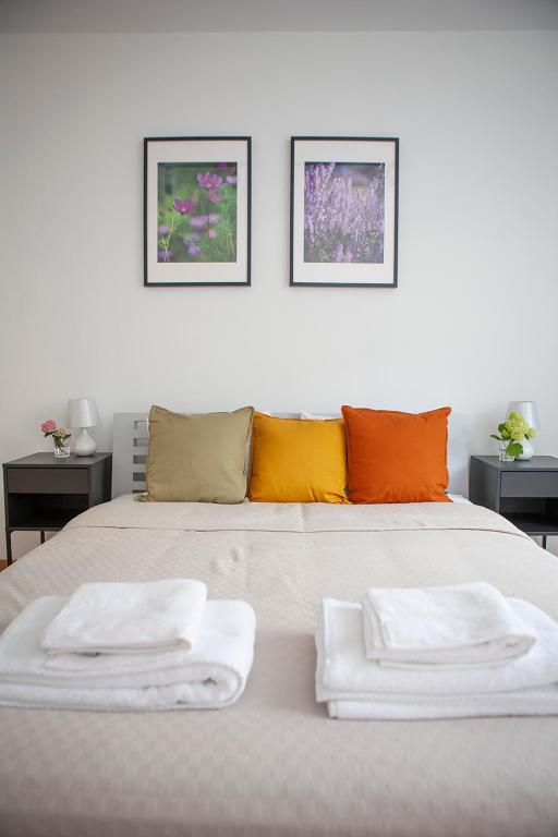 a white bed with two towels on top of it at Apartamenty Jeziorna 40 in Charzykowy
