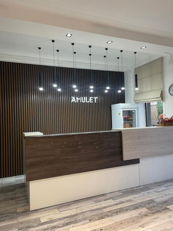 a lobby of an airport with a counter and lights at Гостиница Amulet in Taraz