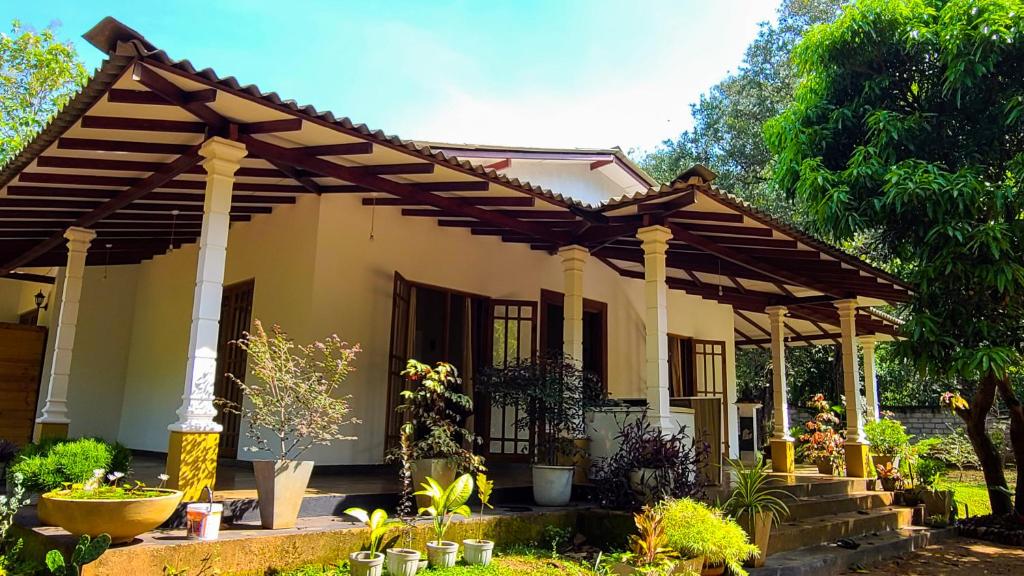 a house with a pergola in a garden at Greenville Resort and Spa in Dambulla