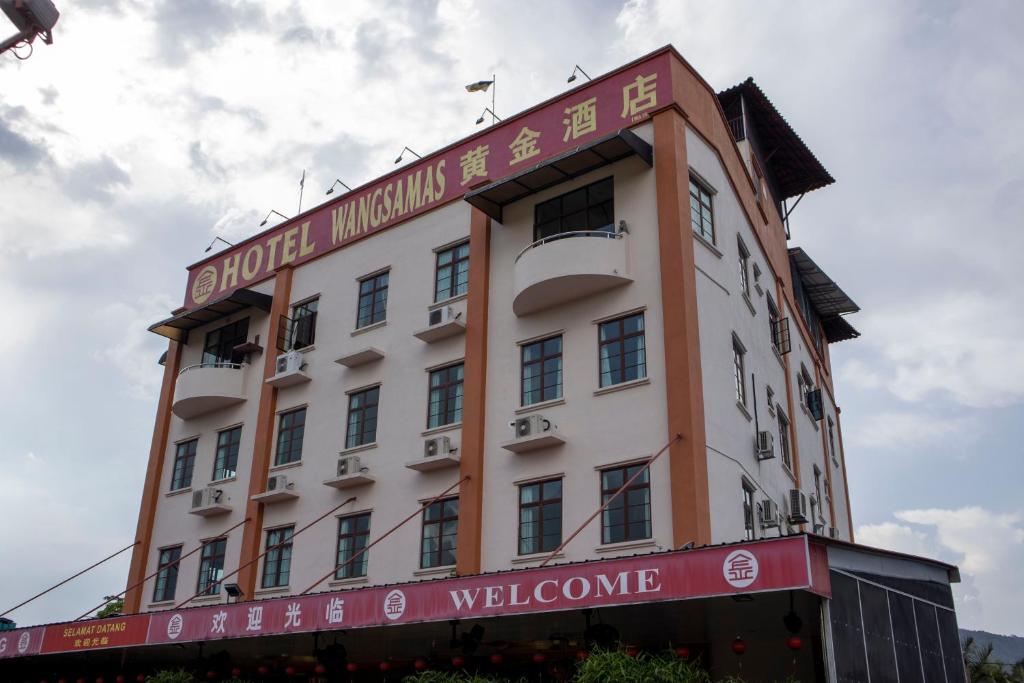 a building with a sign that reads hotel museums welcome at Hotel Wangsamas in Tampin