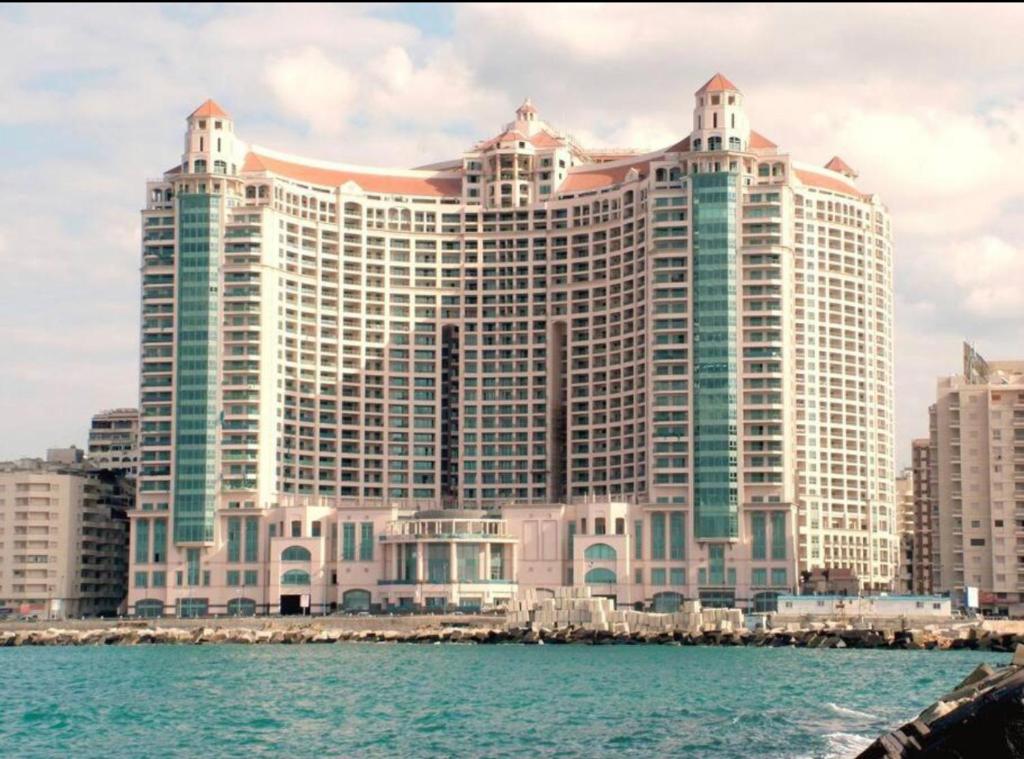 a large building on the shore of the water at Luxurious Grand plaza in Alexandria