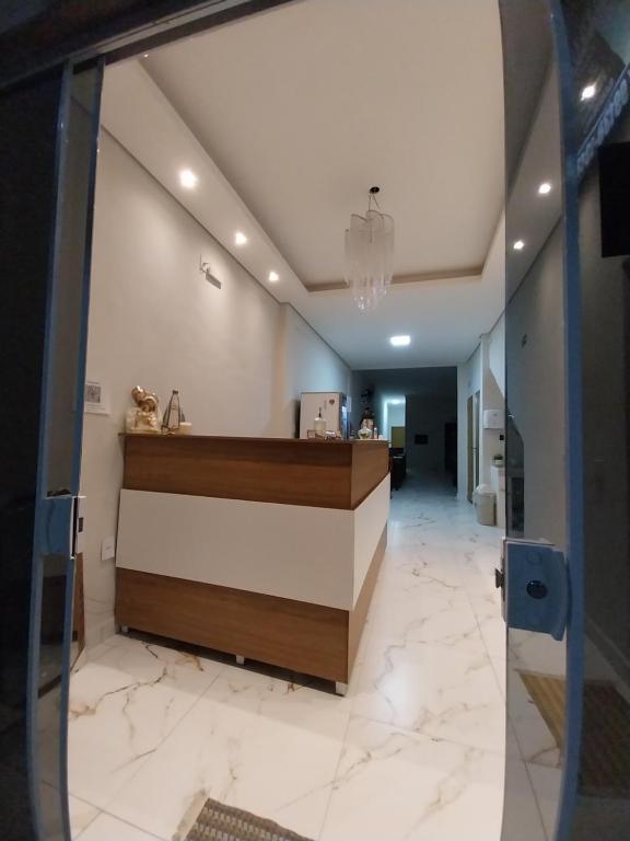 a lobby of a hotel with a reception desk at Aparecida Akuto's Pousada in Aparecida