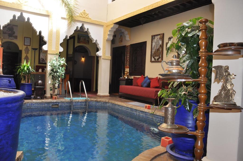 a house with a swimming pool in a living room at Riad des Etoiles in Marrakech