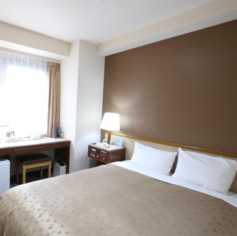 Postel nebo postele na pokoji v ubytování Hotel Aston Hotel Osaka Sakai