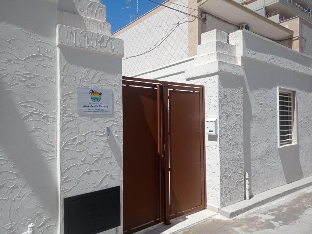 a door in the side of a white building at Lovin Puglia Vacation in Bari