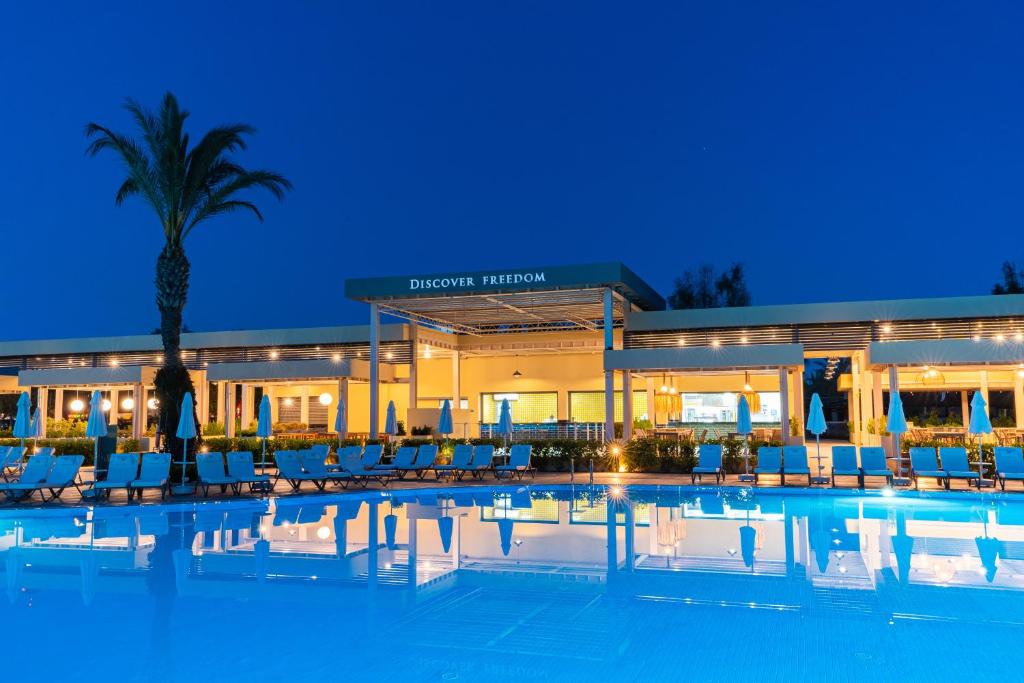 a hotel with a swimming pool in front of a building at Liberty Hotels Lara in Lara