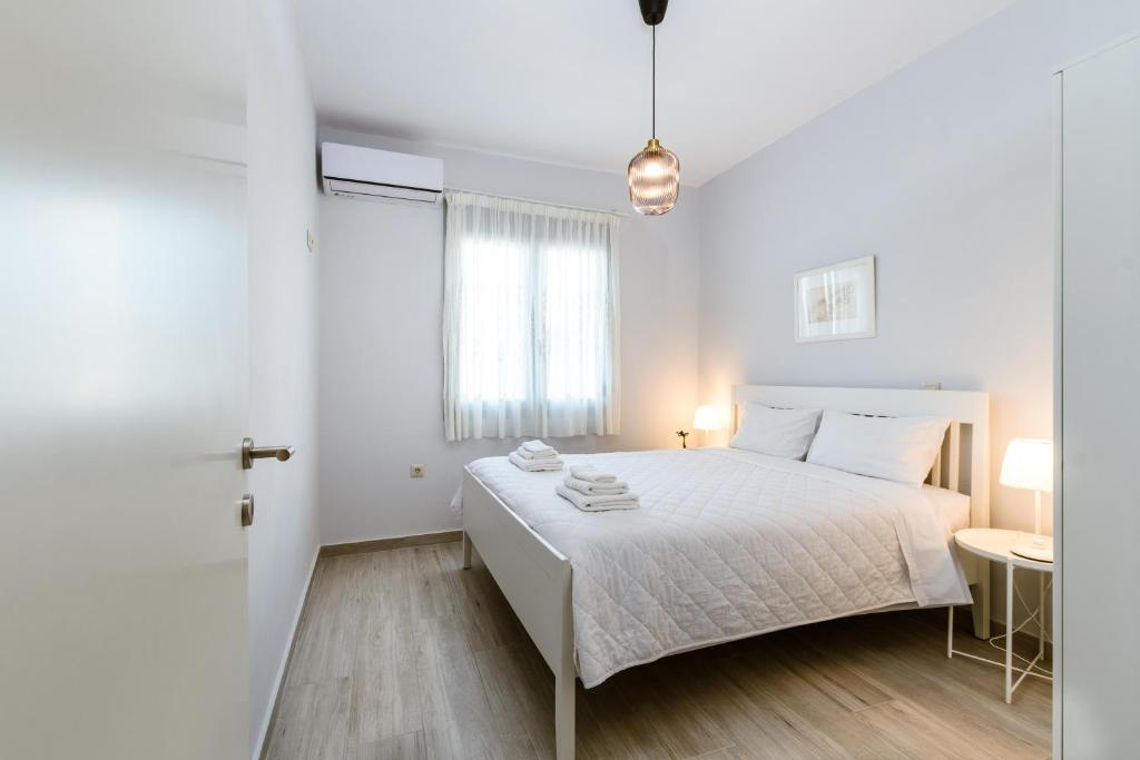 A bed or beds in a room at Akrotiri Seaside Project