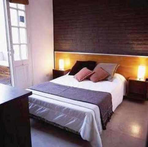 1 dormitorio con 1 cama grande y 2 almohadas en Hostel Carlos Gardel en Buenos Aires