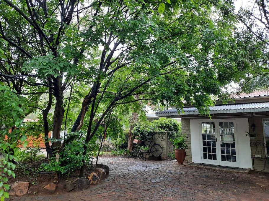 a house with a brick driveway in front of it at Nel's Cottage, a private and peaceful cottage in Benoni