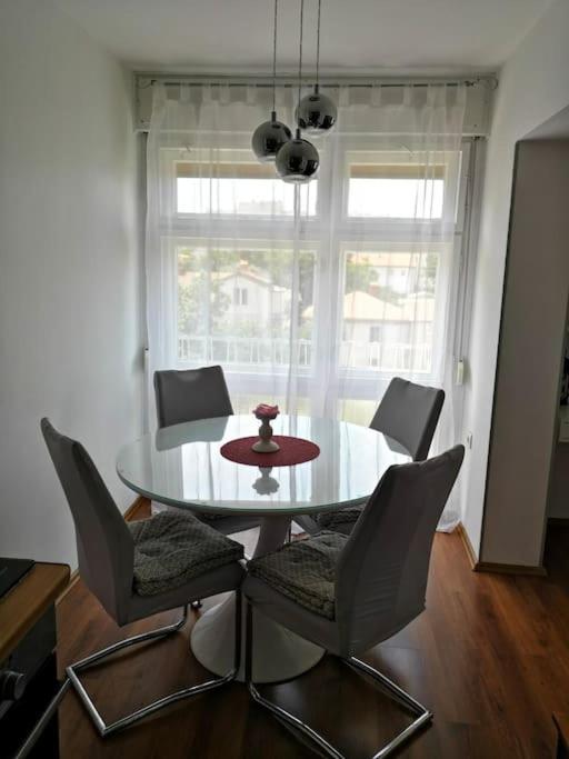 a dining room with a table and chairs and a window at Leda in Pula