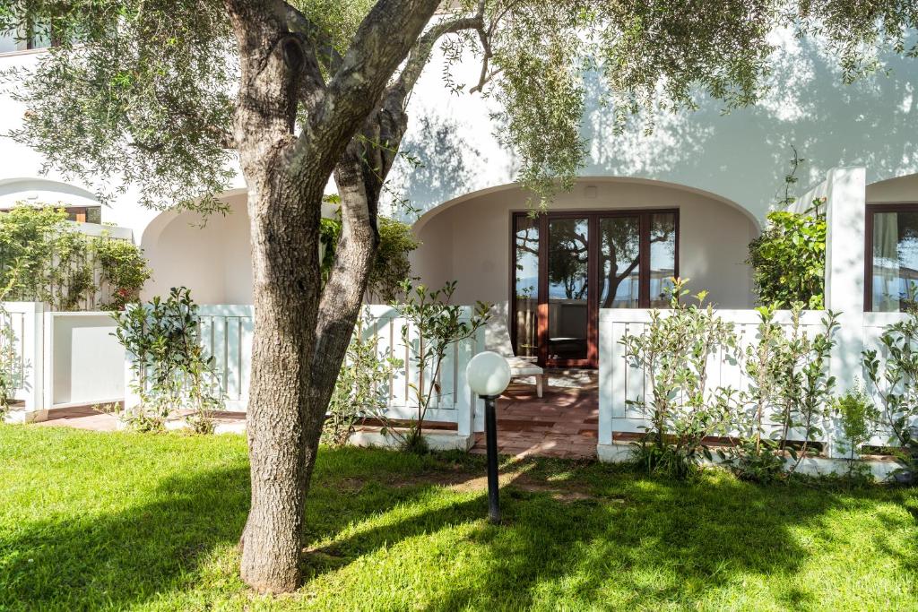 a house with a tree in the yard at Hotel dP Olbia - Sardinia in Olbia