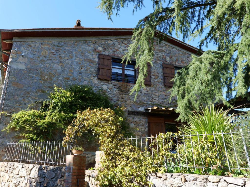 a stone house with a fence in front of it at Holiday Home Il Casale by Interhome in Lama