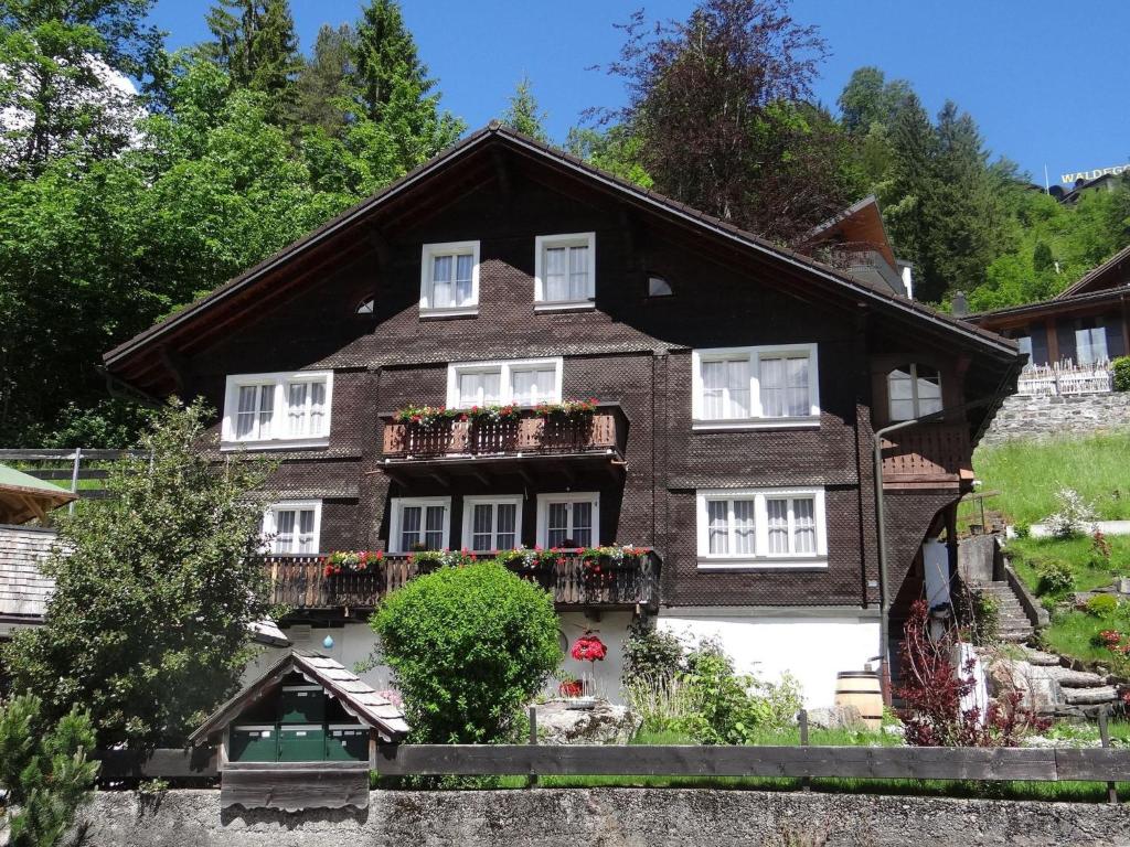 a house with flower boxes on the front of it at Apartment Steinacher 7 by Interhome in Engelberg