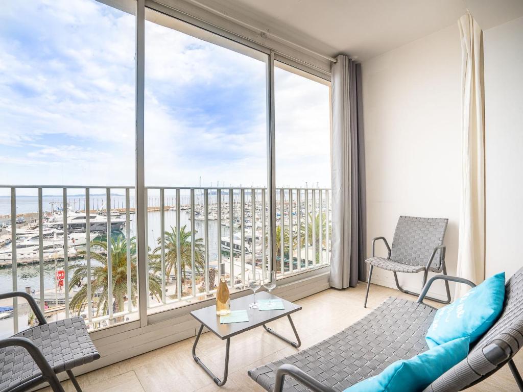 a living room with a view of the ocean at Apartment La Balancine by Interhome in Hyères