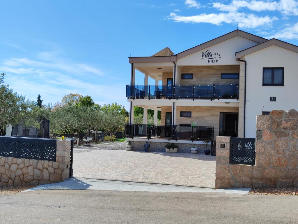 a large white building with a balcony on it at VILLA APARTMENTS FILIP with swimming pool in Starigrad