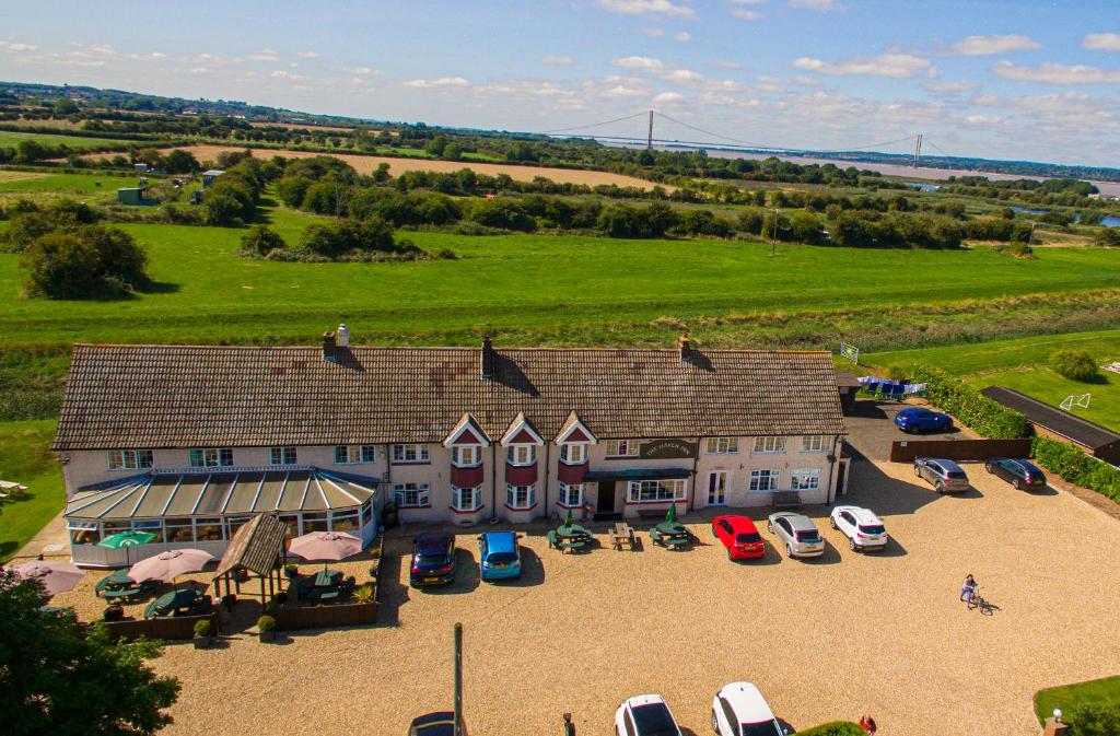 an aerial view of a large house with parked cars at Haven Inn in Barrow upon Humber