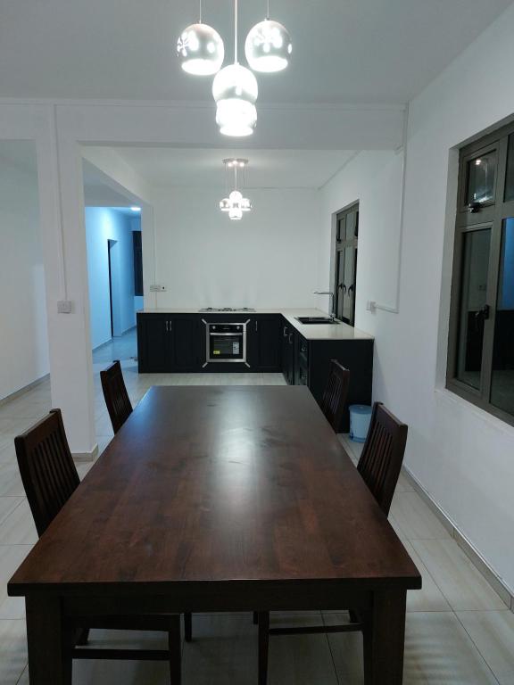 a dining room with a wooden table and chairs at The Oasis of Serenity Villa in Grande Rivière Sud Est