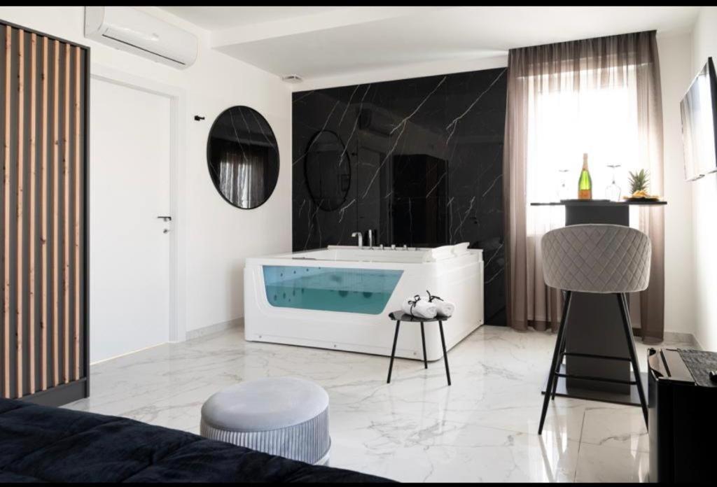 a living room with a bath tub in a room at DIADEMA Luxury Suite in Nardò