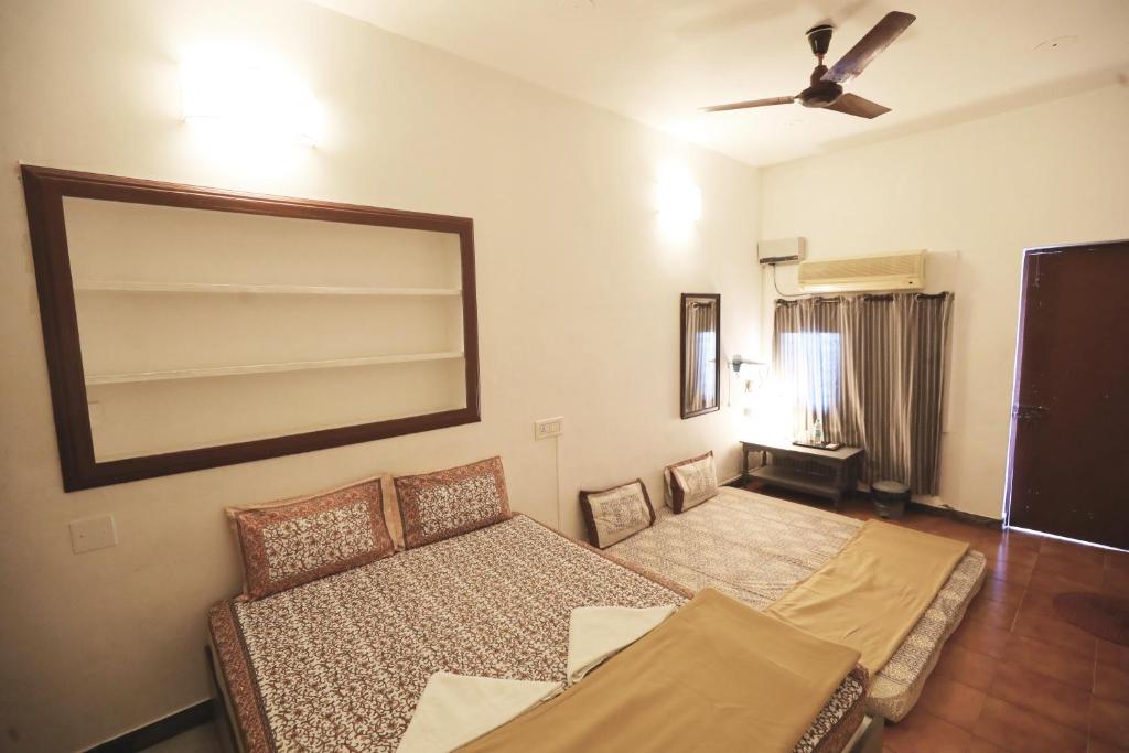 a living room with a couch and a mirror at La Ruelle Guest House in Puducherry