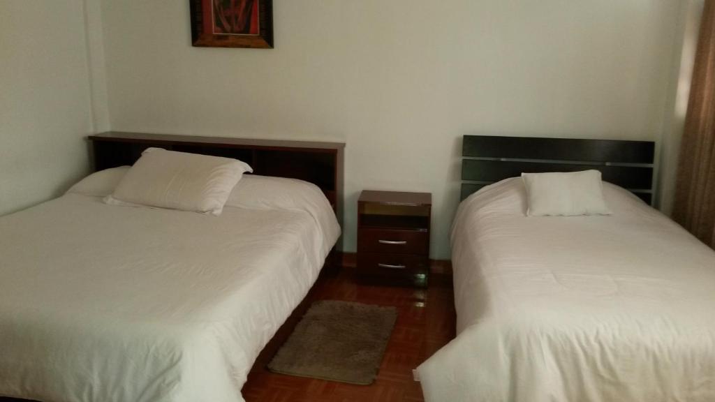 Postel nebo postele na pokoji v ubytování Hostal el Parque Tababela