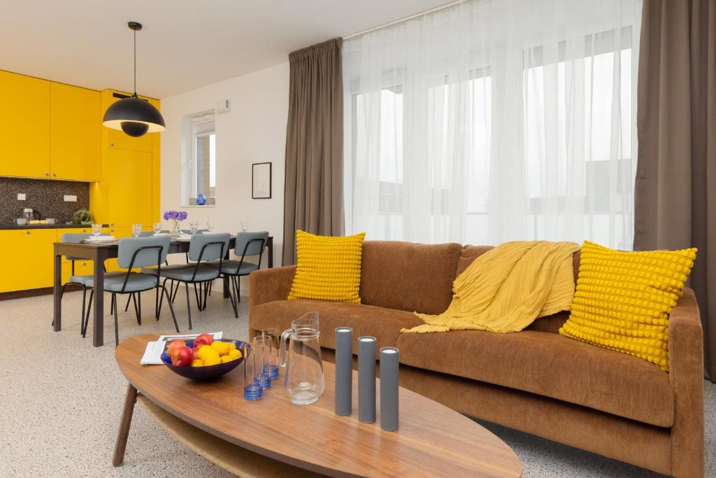 a living room with a brown couch and a table at Trendy & Spacious 3-room Apartament Warsaw Wilanów by Renters in Warsaw