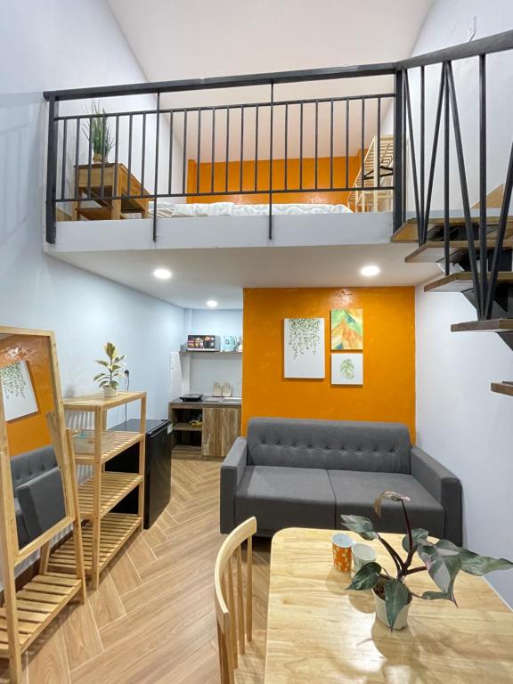 a living room with a couch and a table at VANIA HOUSE - cozy studio near the airport in Ho Chi Minh City
