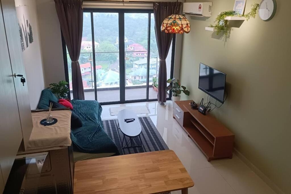 a living room with a large window and a television at Johor Bahru Danga Bay Country Garden 2BR 18 Home+ in Johor Bahru