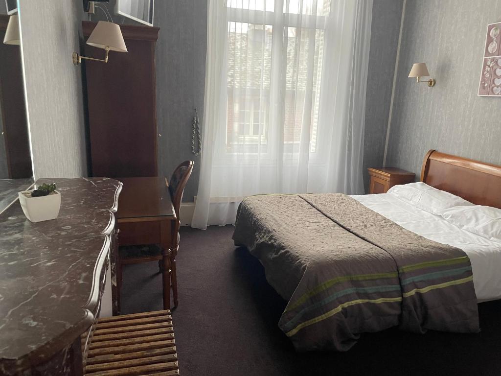 Postel nebo postele na pokoji v ubytování Hotel LE BEAU SITE