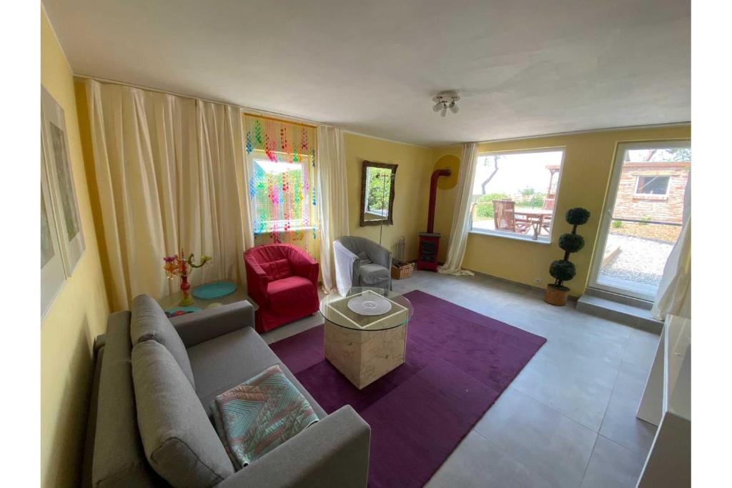 a living room with a couch and a table at Ferienhaus Dorfstrasse 12a in Loddin