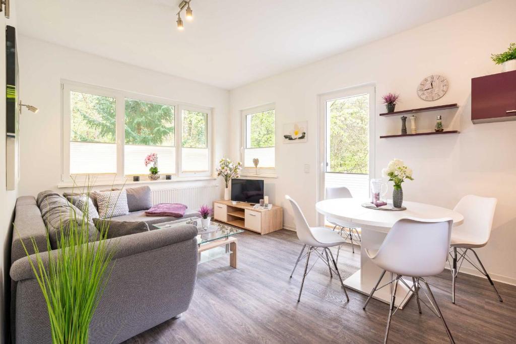 a living room with a couch and a table at Gerhart-Hauptmann-Strasse 1a Ferienhaus Waldblick in Kolpinsee