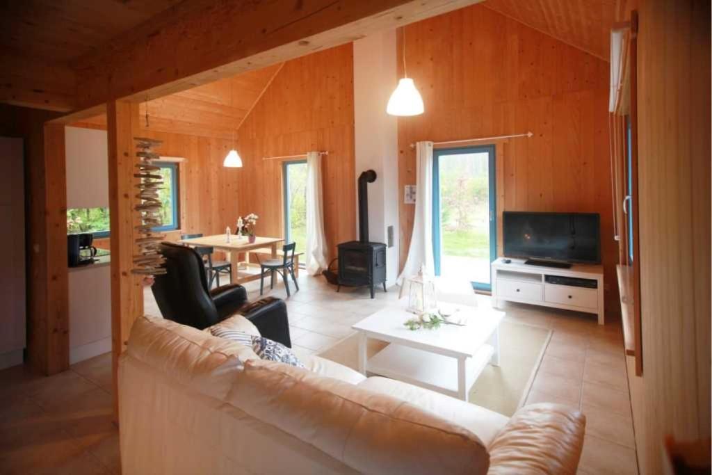 a living room with a couch and a table at Ferienhaus Pampero in Loddin
