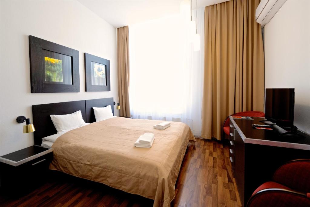 Posteľ alebo postele v izbe v ubytovaní Grand Hotel Trenčin