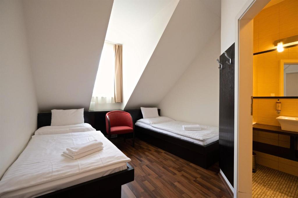 Posteľ alebo postele v izbe v ubytovaní Grand Hotel Trenčin