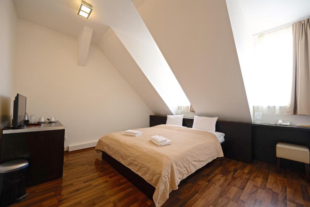 Posteľ alebo postele v izbe v ubytovaní Grand Hotel Trenčin