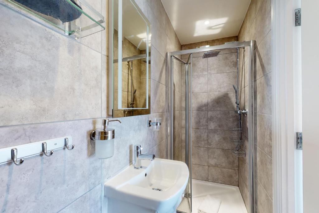 a bathroom with a sink and a shower at Crabbers' Wharf in Portland