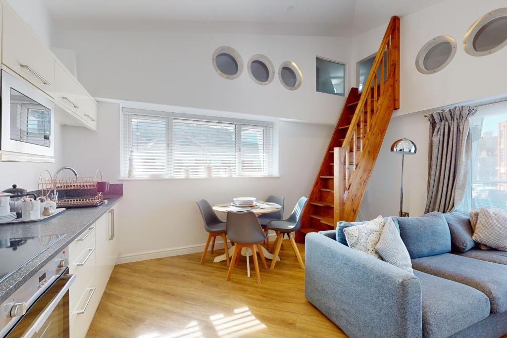 a kitchen and living room with a couch and a table at Crabbers' Wharf in Portland