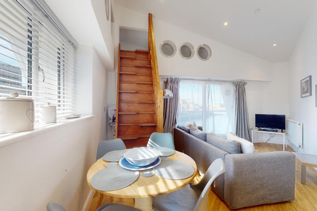 a living room with a table and a couch at Crabbers' Wharf in Portland