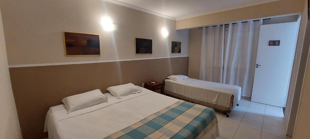 a hotel room with two beds in a room at Ecopousada Miriti in Belém