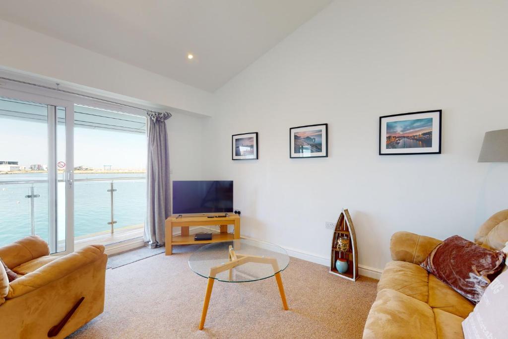 a living room with a couch and a television at Crabbers' Wharf in Portland
