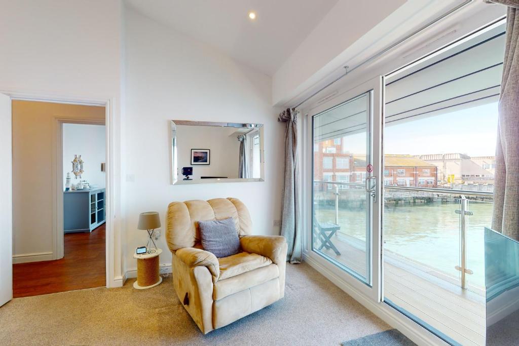 a living room with a chair and a large window at Crabbers' Wharf in Portland