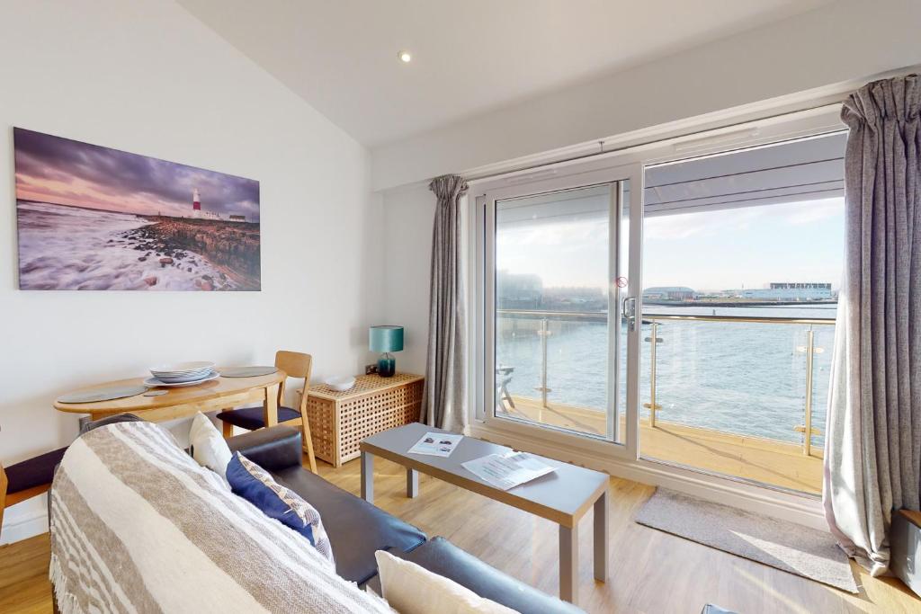 a living room with a couch and a large window at Crabbers' Wharf in Portland