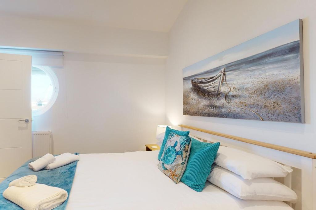 a bedroom with a bed with a painting on the wall at Crabbers' Wharf in Portland