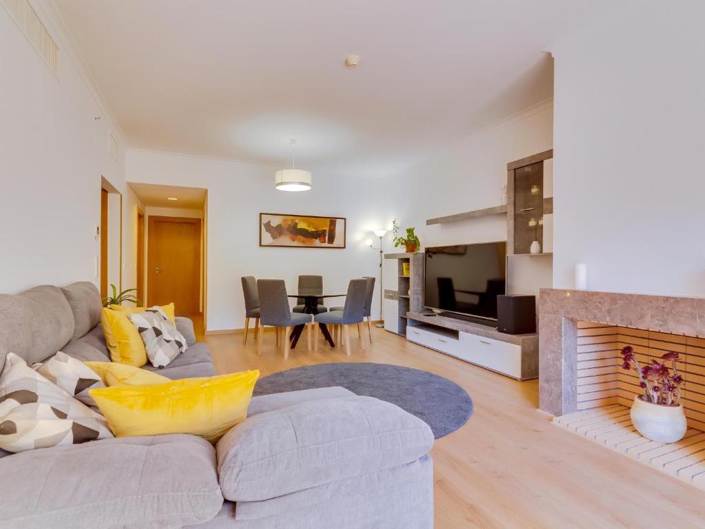 a living room with a couch and a fireplace at AL - Apartamento Vila Sol AG in Vilamoura