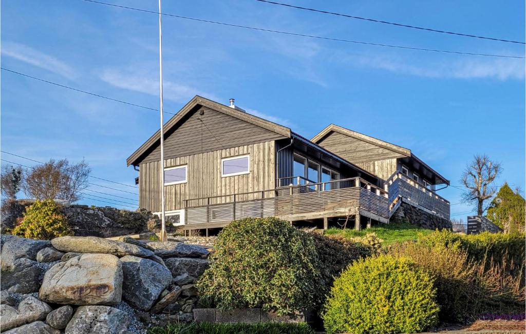 a house on top of a hill with rocks at Stunning Home In Hvik With Wifi 