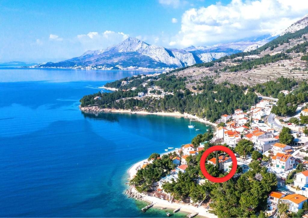 an island in the water with a red circle at Beach Apartments Borovina in Stanići