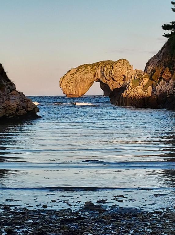 an arch in the water near a beach at Hotel Hontoria in Hontoria