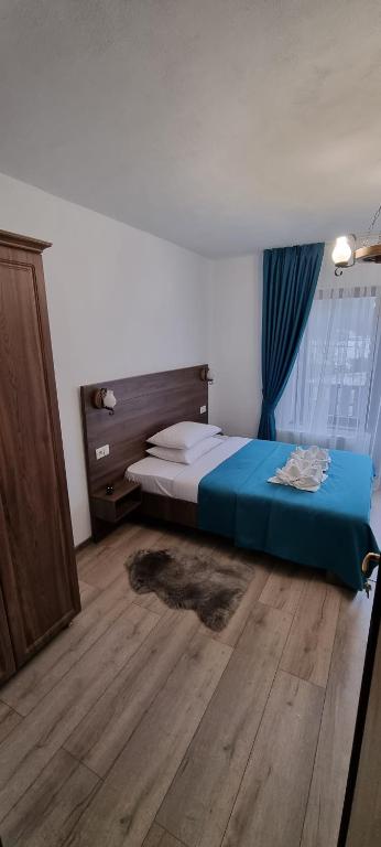 Postel nebo postele na pokoji v ubytování Popasul Moților