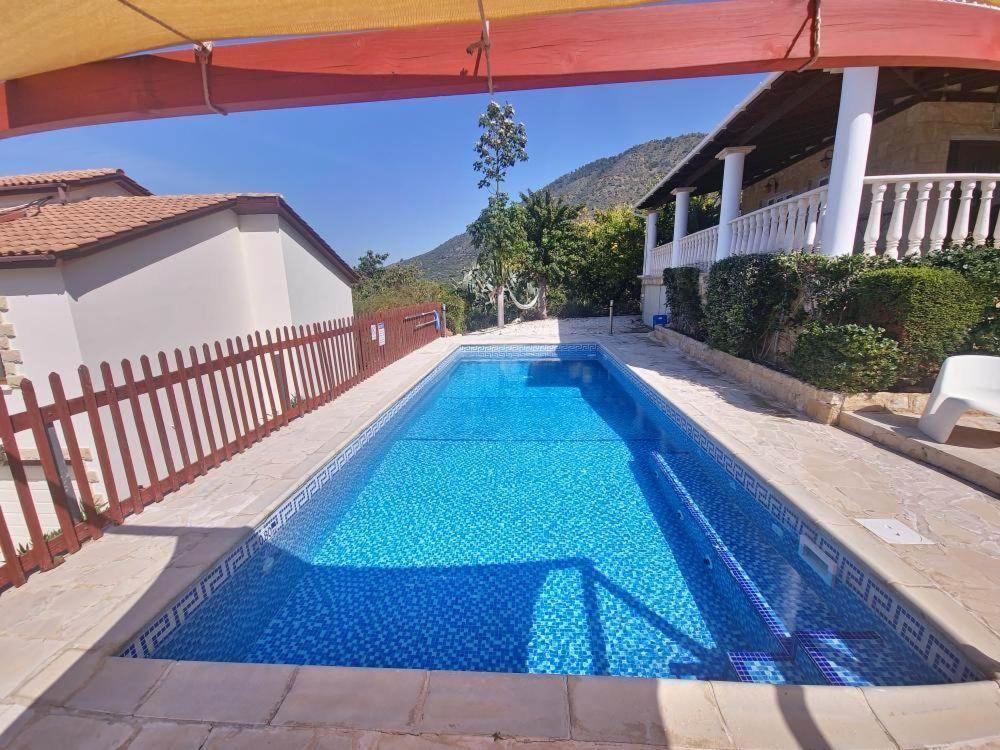 a swimming pool in a house with a blue pool at Pomos Harbourbiew Villa in Pomos